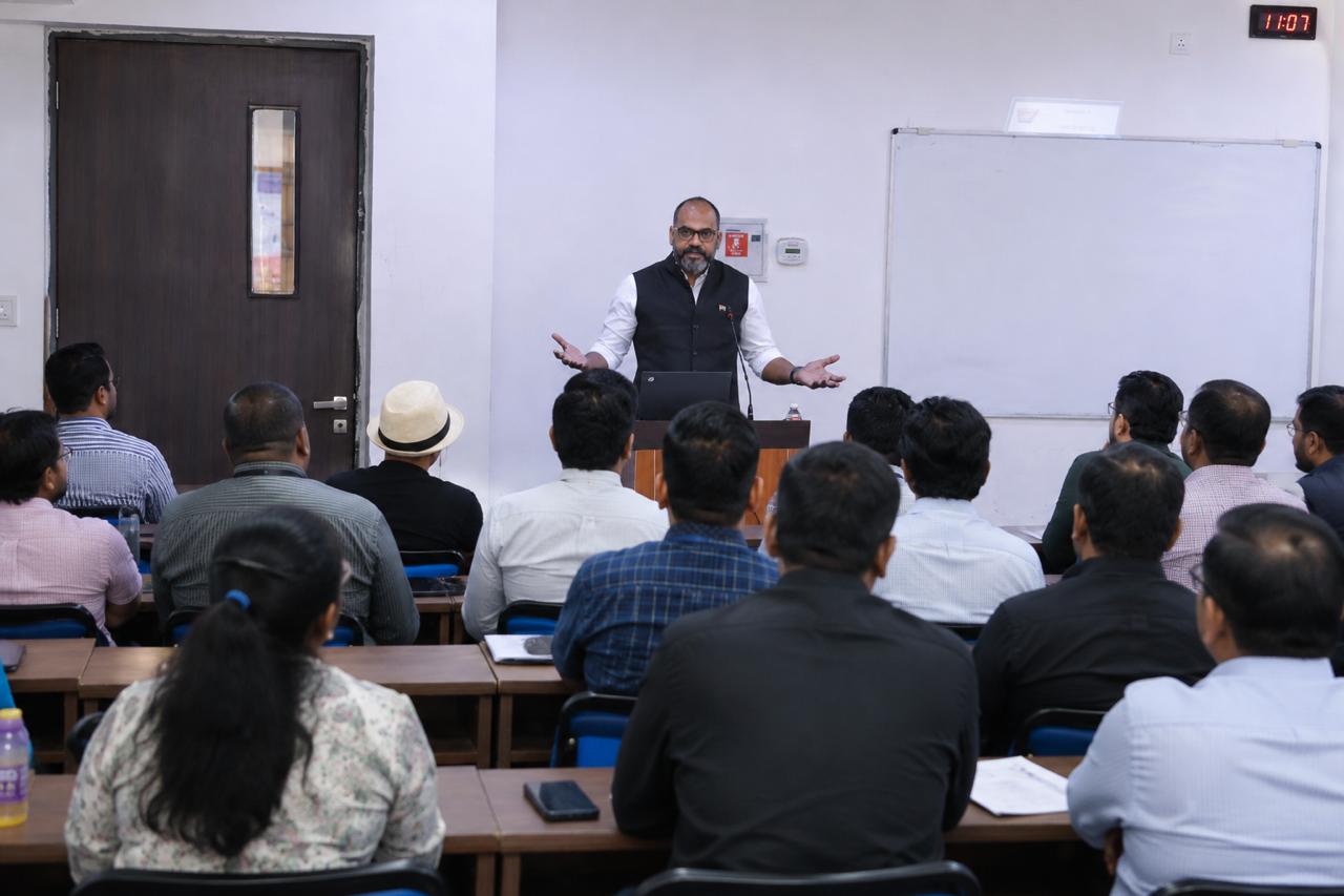 Vijay Sharma addressing a packed classroom of business leaders